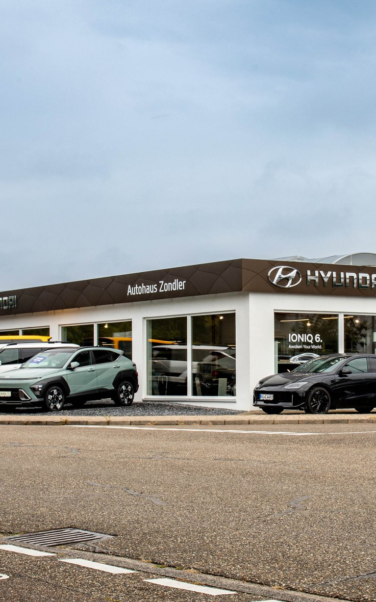 Außenansicht des Hyundai Autohaus Zondler in Graben-Neudorf mit Showroom, Hyundai Fahrzeugen vor dem Gebäude und S&G Branding